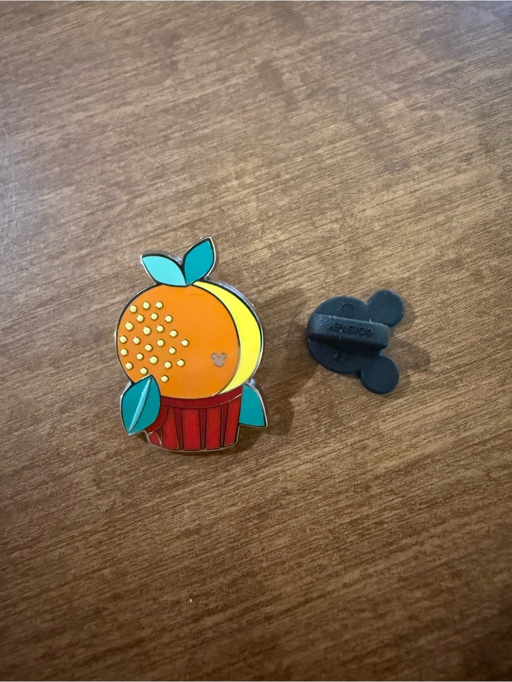 Hidden Mickey orange bird cupcake pin
